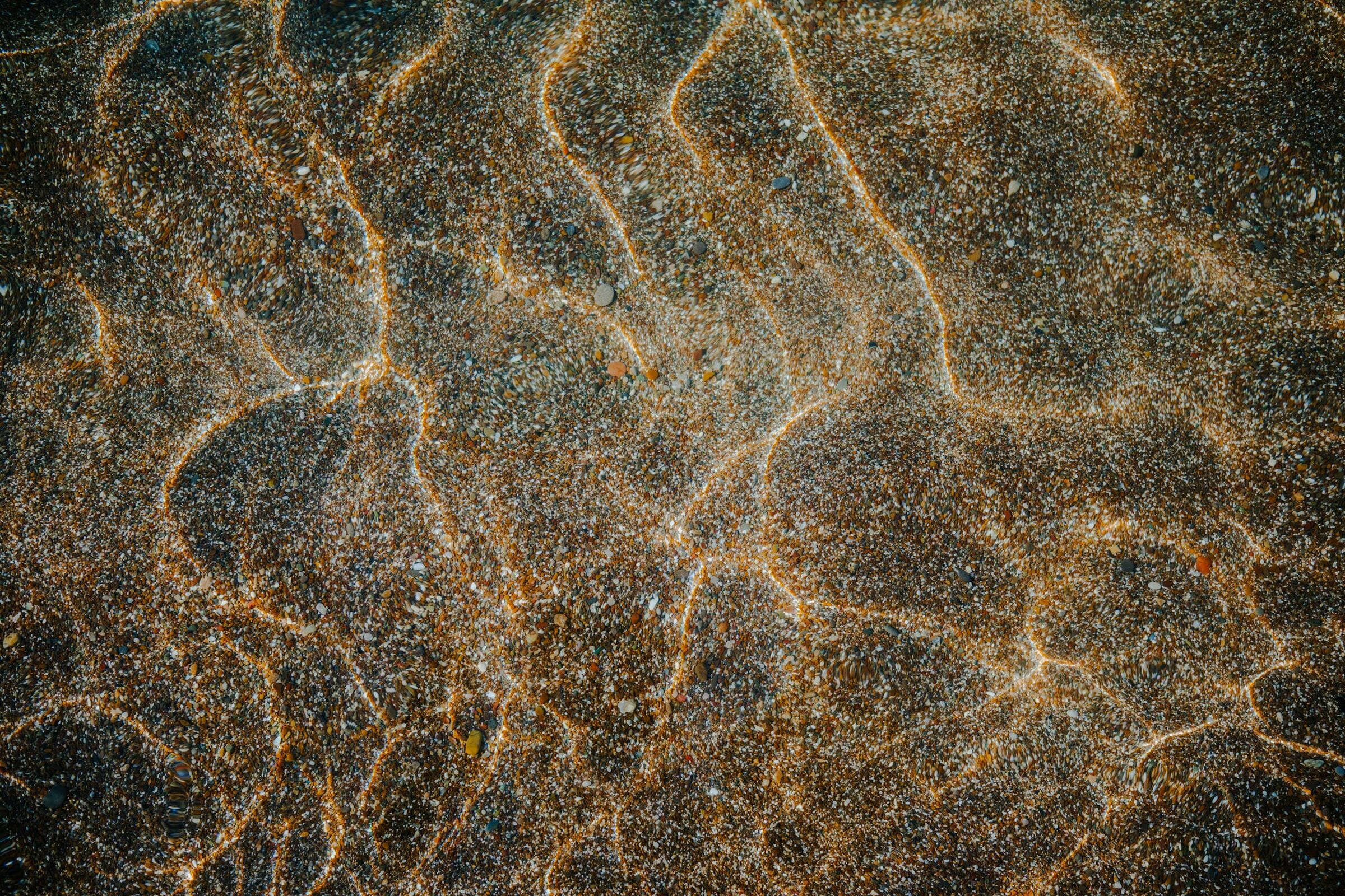 Sunlight rippling across a sandy seabed