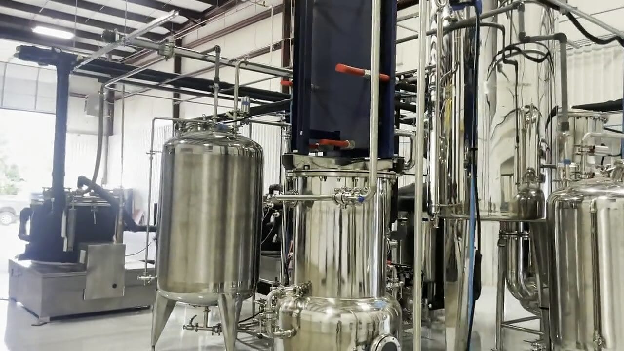 Stainless tanks under a plate heat exchanger on a cold-ethanol line