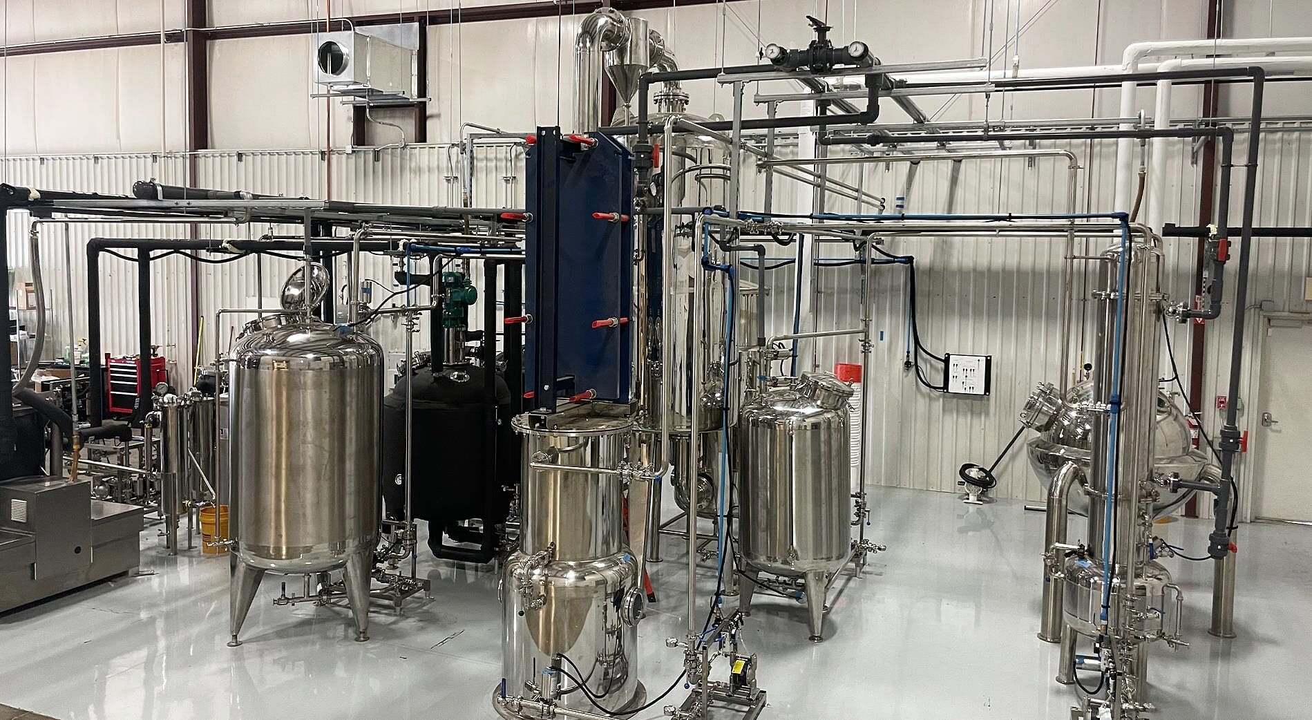 A cold-ethanol line: tanks, plate heat exchanger and falling-film evaporator