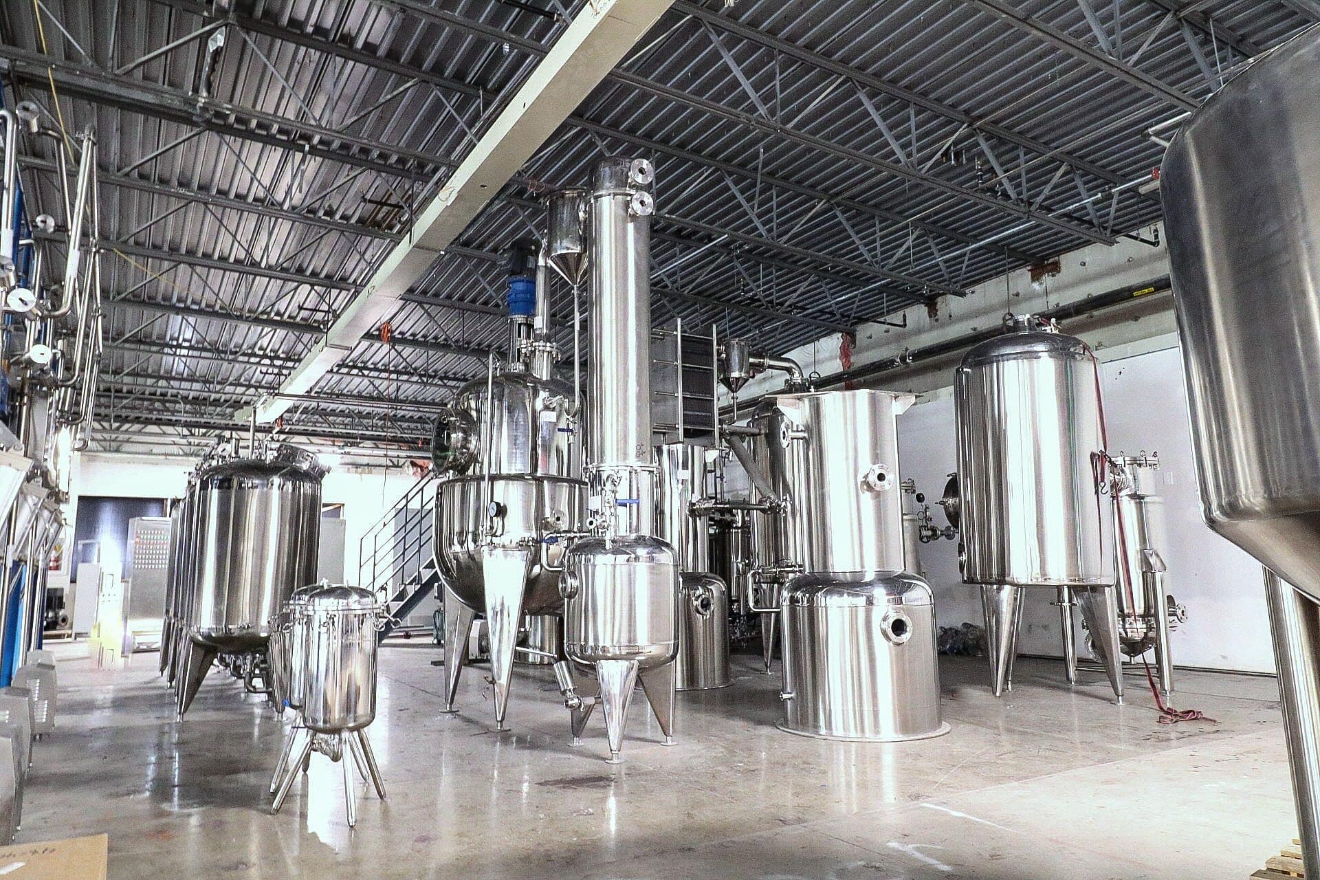 Evaporators and stainless tanks in a production hall